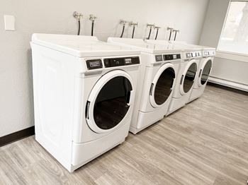 two washers and two dryers in a laundry room